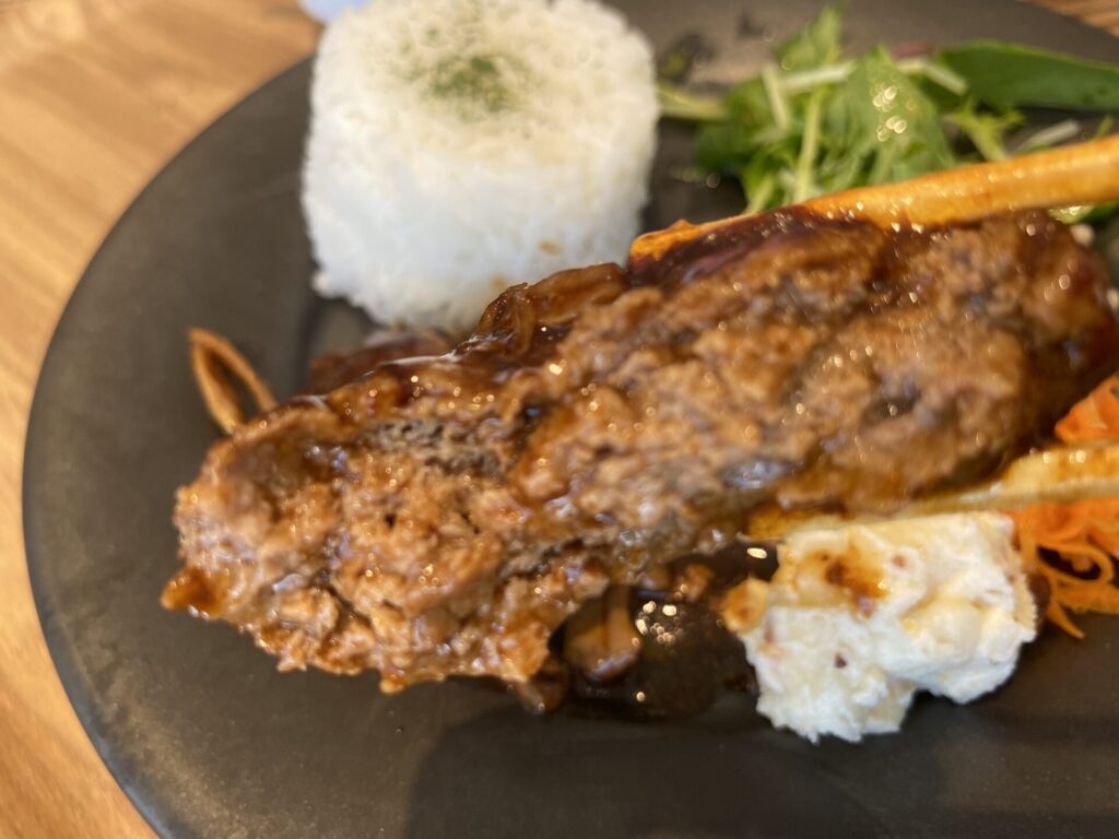 箸で割ったハンバーグから肉汁があふれる様子